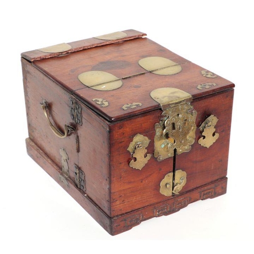 1004 - A Chinese hardwood dressing table chest with fitted interior and brass mounts, 30cms wide. (a/f)