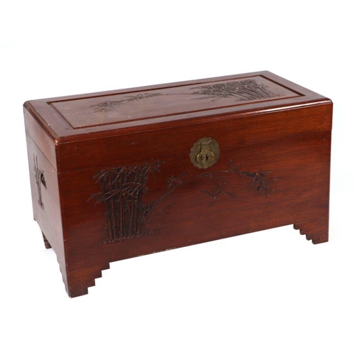 1019 - A Chinese carved camphorwood chest, 100cms wide.