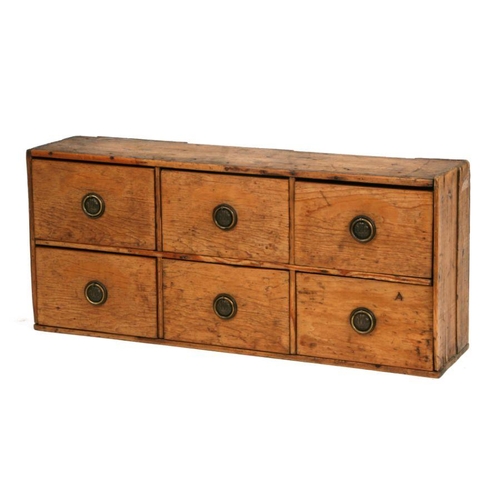 1023 - A 19th century stripped pine bank of six drawers with later brass handles, 92cms wide.