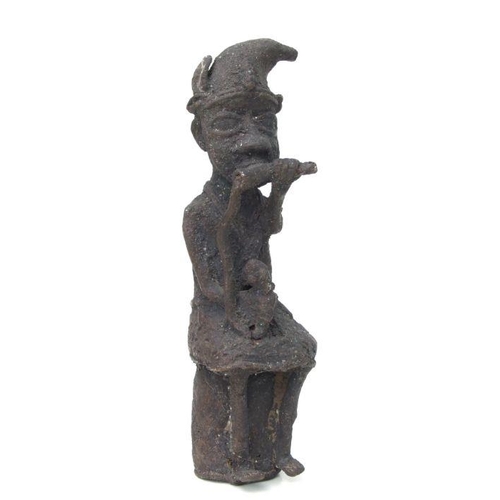 105 - A Benin bronze figural group, 22cms high; together with a similar figure of a seated musician, 25cms... 