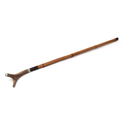 135 - A bamboo shafted sword stick with a 50cms (19.75ins) triangular section blade and stag horn handle. ... 