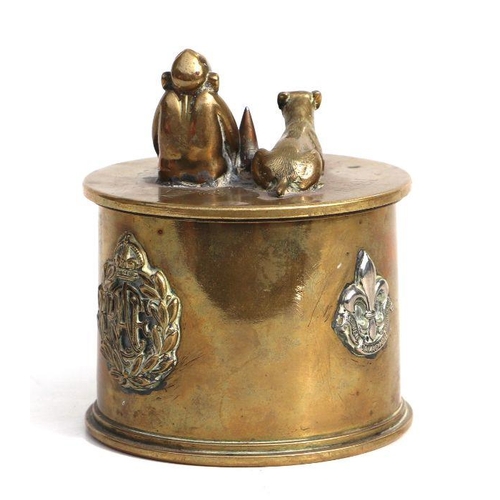 147 - A WWI trench art tobacco jar and over with applied cap badges including RF, American North West Moun... 