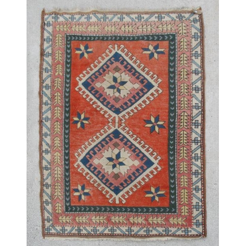 191 - A Caucasian rug with central medallions on a red ground within a multi border, 192 by 129cms; togeth... 