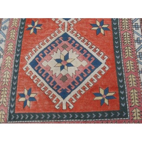 191 - A Caucasian rug with central medallions on a red ground within a multi border, 192 by 129cms; togeth... 