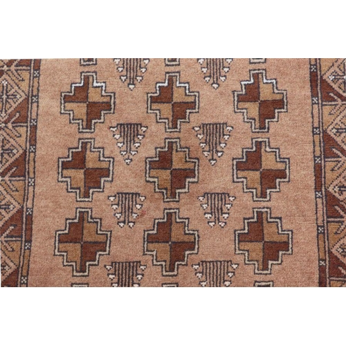 197 - A Persian carpet with repeating geometric patterns on a brown ground, 63 by 50cms; together with sma... 