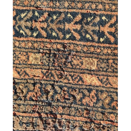 198 - A Persian rug with repeating guls on a brown ground within a multi border, 204 by 130cms.Condition R... 