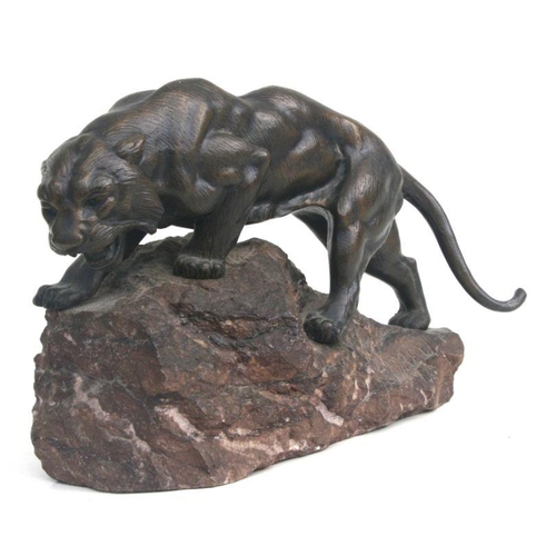 473 - James Andrey (early 20th century French) a bronze study of a prowling tiger, on a naturalistic marbl... 