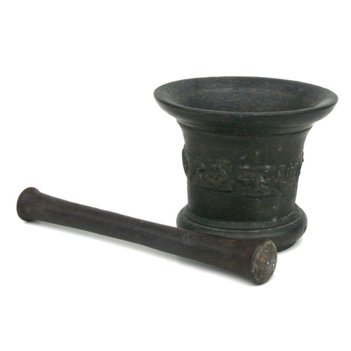 492 - A large cast bronze mortar and pestle, probably 18th century, 15cms high.