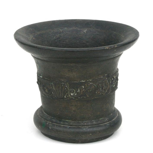 492 - A large cast bronze mortar and pestle, probably 18th century, 15cms high.