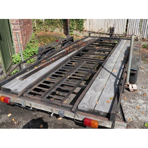 56 - A twin axle car transporter with manual winch and trailer board, approx 14ft in length.