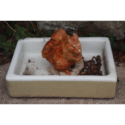 64 - A ceramic butler's sink, 62cms wide together with a garden figure of a squirrel (2)