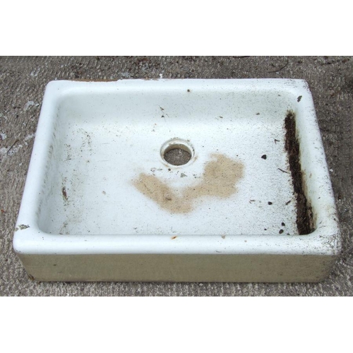 64 - A ceramic butler's sink, 62cms wide together with a garden figure of a squirrel (2)