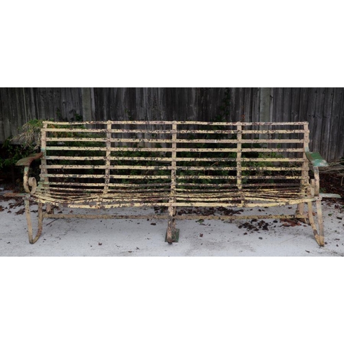 73 - A large well weathered wrought iron garden bench, 237cms wide.