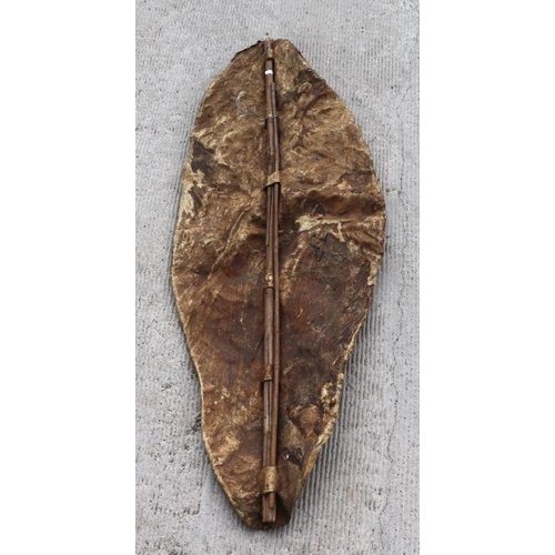 95 - An African tribal animal hide shield, 128cms long.