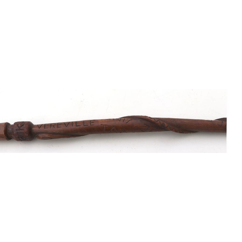 97 - A carved African tribal walking stick, the shaft carved with an intertwined snake, the handle carved... 