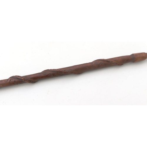 97 - A carved African tribal walking stick, the shaft carved with an intertwined snake, the handle carved... 