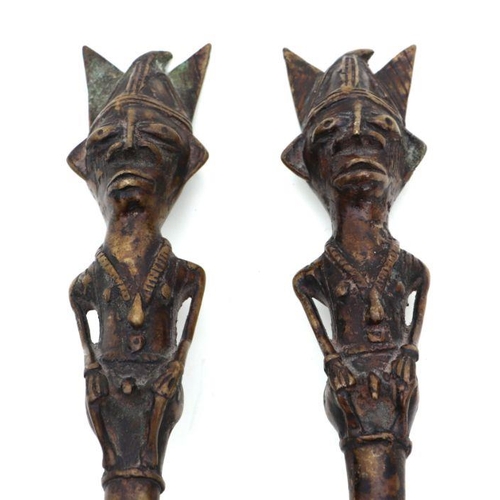 99 - A pair of Benin bronze style knives with figural handles, each 46cms long (2).