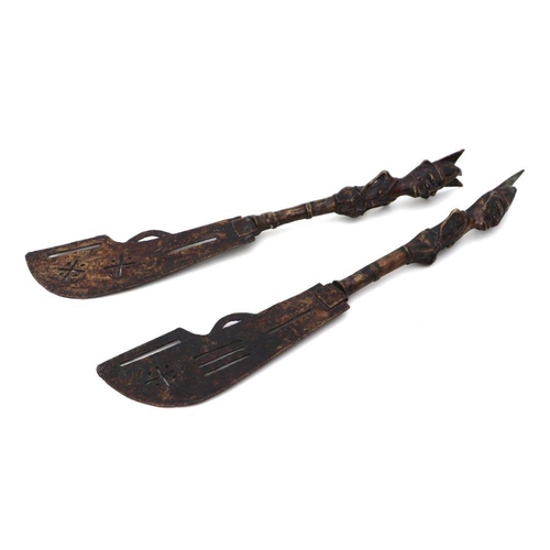 99 - A pair of Benin bronze style knives with figural handles, each 46cms long (2).