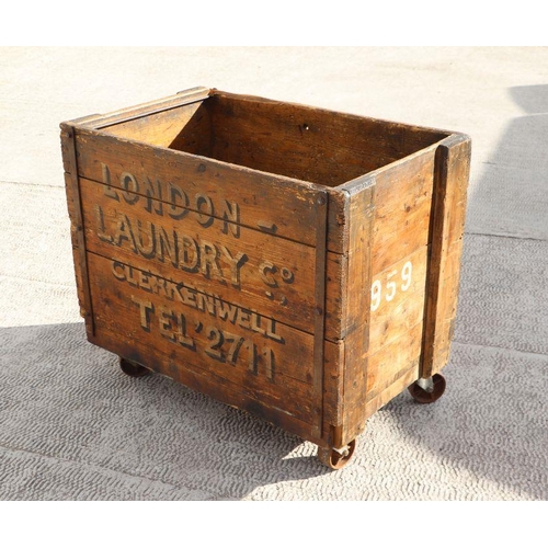 998 - A pine laundry cart 'London Laundry Co, Clerkenwell', on four cast wheels, 87cms wide.