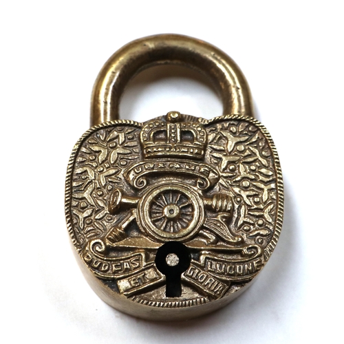 124 - A heavy brass Artillery Ubique padlock with key in full working order. 6.5cms (2.5ins) wide by 9cms ... 