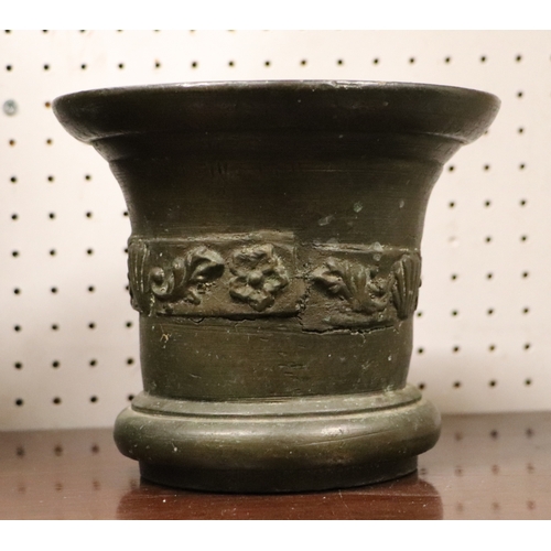 492 - A large cast bronze mortar and pestle, probably 18th century, 15cms high.