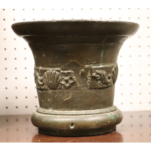 492 - A large cast bronze mortar and pestle, probably 18th century, 15cms high.