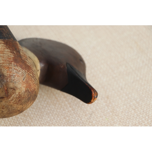 175 - A 19th century painted carved wooden decoy duck, 36cms long.