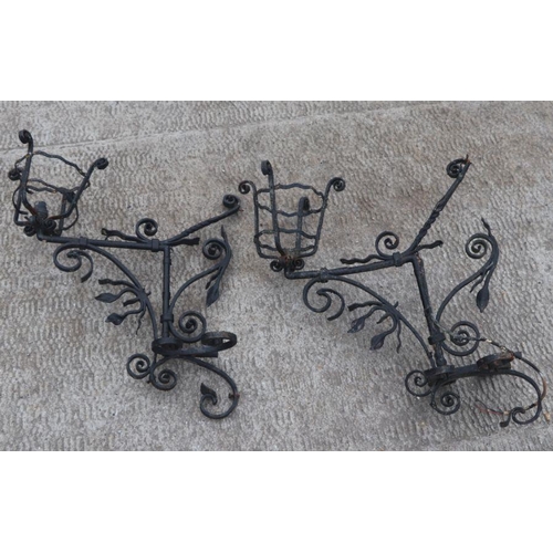 122 - A pair of wrought iron wall light brackets with scroll decoration, each 50cms wide (2).