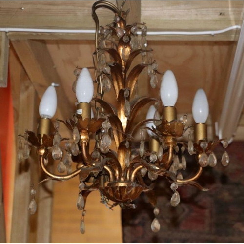 126 - A six-branch gilt metal ceiling light with glass prismatic drops.