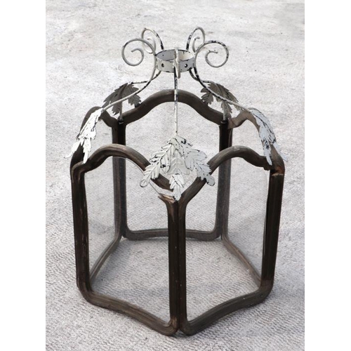 131 - A large hexagonal hall lantern with arched panels and distressed painted metal support, 88cms high.