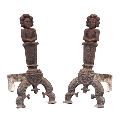 137 - A pair of figural cast iron fire dogs, basket, accompanying set of wrought iron fire irons and a wro... 