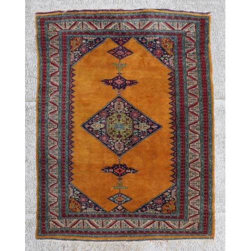 145 - A Persian rug with geometric design on a golden ground, 128 by 185cms.