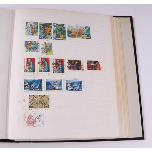 41 - Four albums containing assorted World stamps to include Singapore, South Africa, Jamaica, Australia ... 