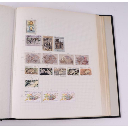 41 - Four albums containing assorted World stamps to include Singapore, South Africa, Jamaica, Australia ... 