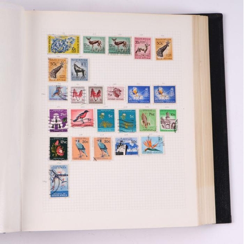 41 - Four albums containing assorted World stamps to include Singapore, South Africa, Jamaica, Australia ... 