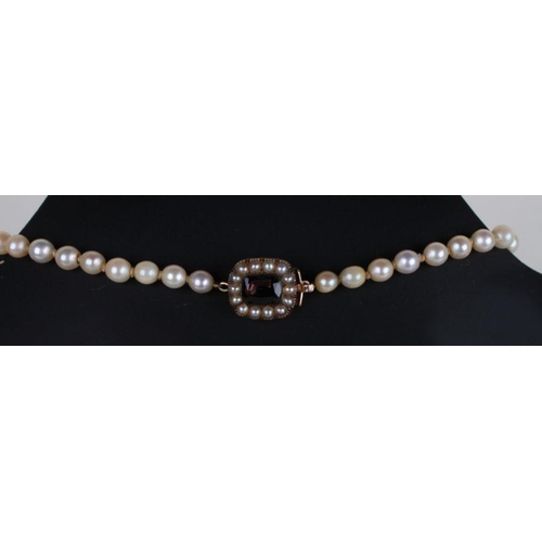 502 - A Victorian pearl necklace with yellow coloured metal and gem set clasp.