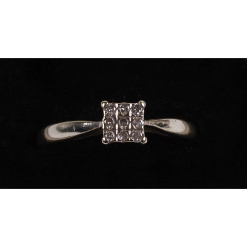 503 - A 9ct white gold and diamond panel ring, approx UK size 'O'.