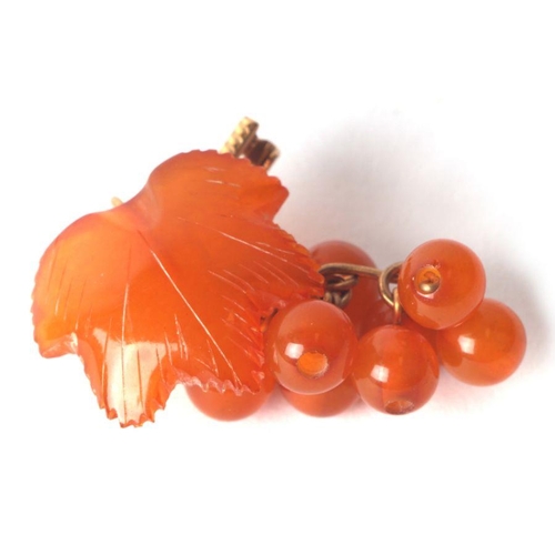 508 - A yellow metal mounted (stamped 18k) amber brooch in the form of grapes and vine leaf.