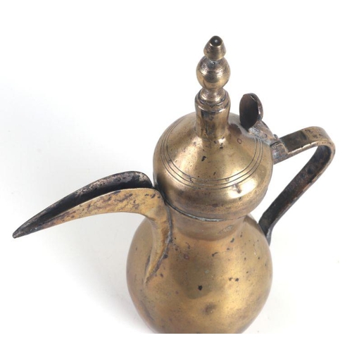 534 - A Turkish / Islamic brass dallah coffee pot, 30cms high.