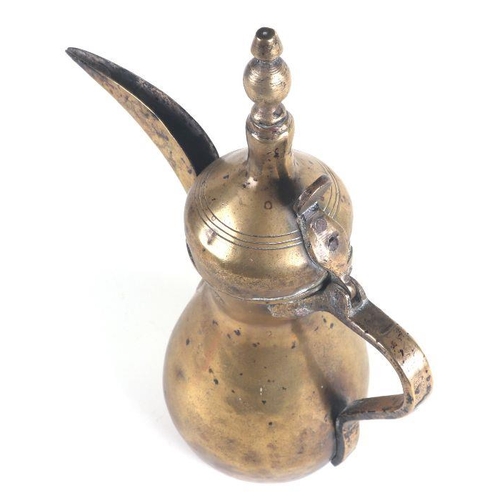 534 - A Turkish / Islamic brass dallah coffee pot, 30cms high.