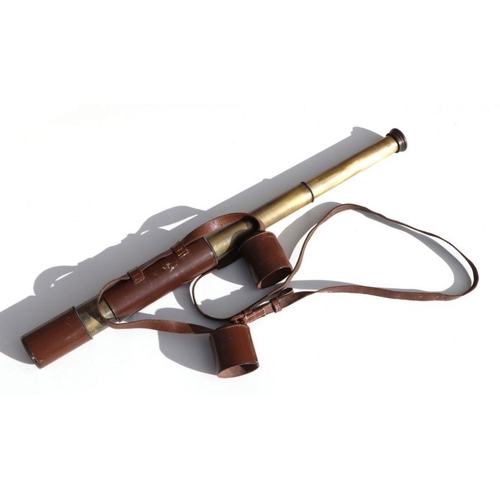 64 - A vintage two draw field telescope complete with its original stitched leather covering and linked e... 