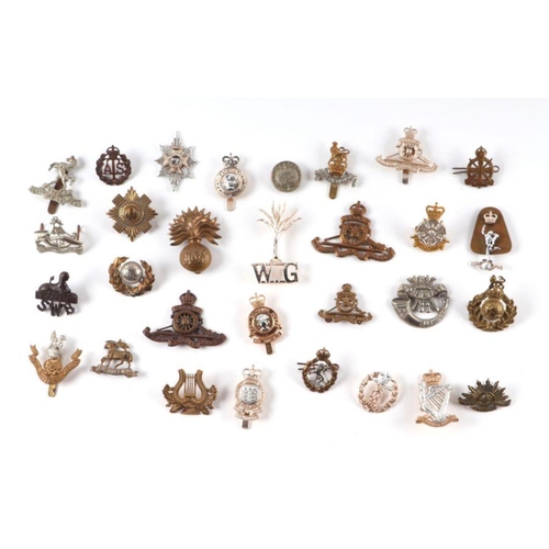 91 - A collection of military cap badges to include Royal Scots, Royal Engineers, and others.