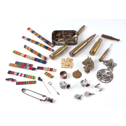 96 - A small collection of militaria to include belt buckles, cap badges, medal ribbons, inert bullets an... 