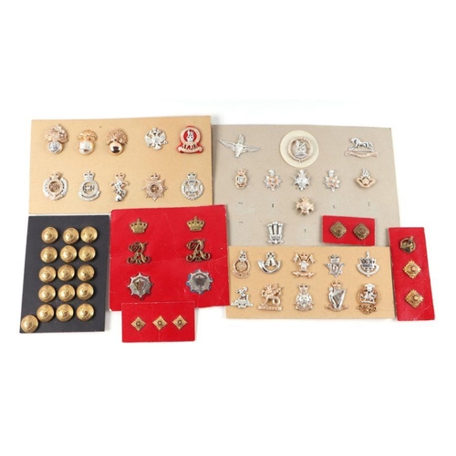 97 - A collection of military buttons and cap badges for various regiments to include Wessex, Royal Artil... 