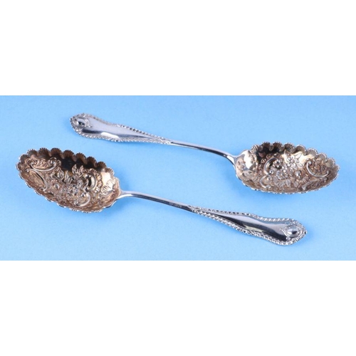 1080 - A pair of late Victorian silver berry serving spoons with gilt embossed bowls, Birmingham 1900, 23cm... 