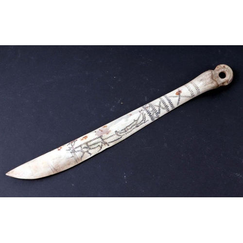 1498 - An Inuit carved and engraved bone snow knife, 25cms long.