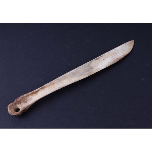 1498 - An Inuit carved and engraved bone snow knife, 25cms long.