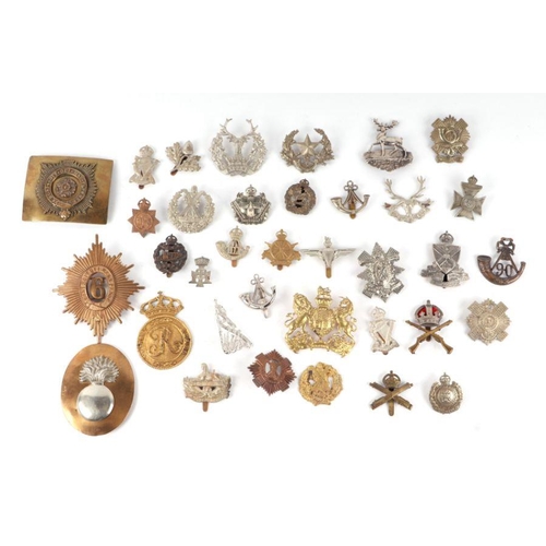 1503 - A large quantity of metal military badges to include Royal Artillary, Cameroons, Royal Lancers, Ligh... 