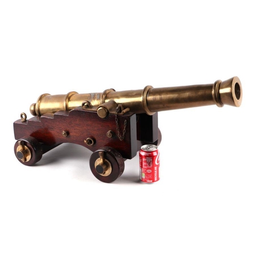 1510 - A brass or bronze cannon mounted on a wooden carriage with brass/bronze fittings and a wooden wedge.... 