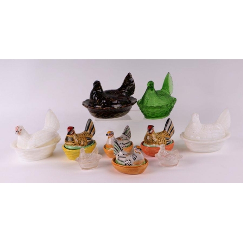 152 - A group of ceramic and glass hens on nests to include two milk glass examples, largest 14cms wide (1... 